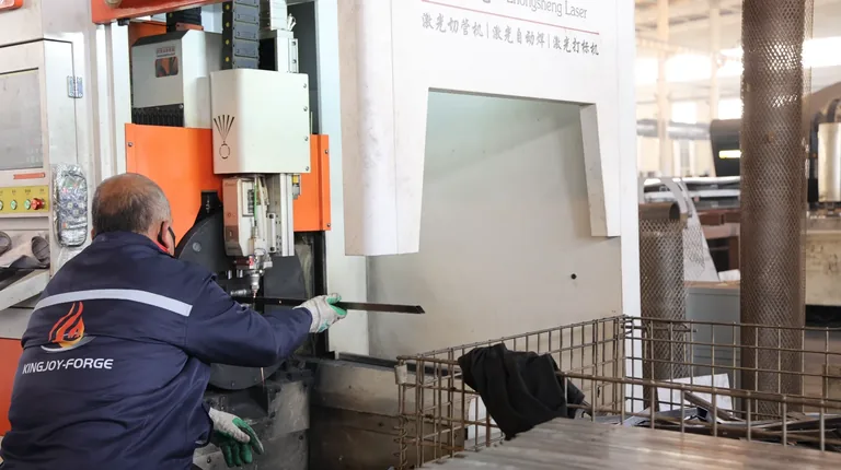 Operator working at a tube laser cutting machine